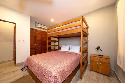 a bedroom with a bunk bed and a ladderweredweredwered at Newly Remodeled Beachfront Condo, Ground-Floor Terrace & Direct Access to Playa Flamingo in Playa Flamingo