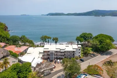 an aerial view of a resort and the ocean at Newly Remodeled Beachfront Condo, Ground-Floor Terrace & Direct Access to Playa Flamingo in Playa Flamingo