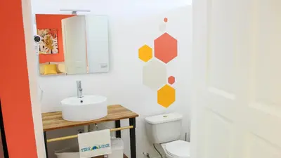 a bathroom with a sink and a toilet at Tee-K Lodge Tamarindo in Tamarindo
