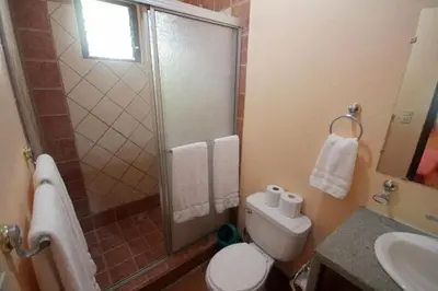a bathroom with a shower and a toilet and a sink at Nosara Paradise Rentals in Nosara