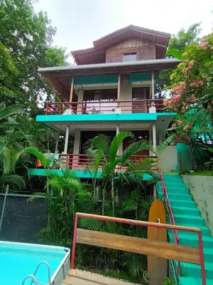 a house with a pool in front of it at Chicama : Burnt Toast Surfcamp in Nosara