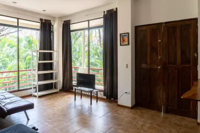 a living room with a couch and a chair at Chicama : Burnt Toast Surfcamp in Nosara