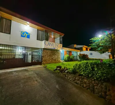 a building with a sign on the side of it at Hotel Casa Tago in Alajuela City
