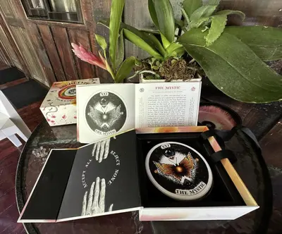 a table topped with two books and a plant at Casa Morpho Uvita Guesthouse in Uvita