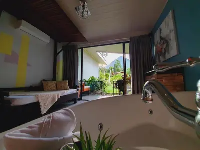 a bath tub in a bathroom with a window at Yellow Tree Suites in Fortuna