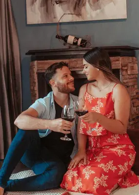 a man and a woman holding glasses of wine at Yellow Tree Suites in Fortuna
