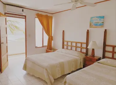 a bedroom with two beds and a window at Flamingo Marina Hotel in Playa Flamingo