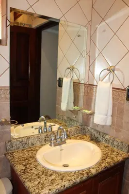 a bathroom with a sink and a mirror at Flamingo Marina Hotel in Playa Flamingo