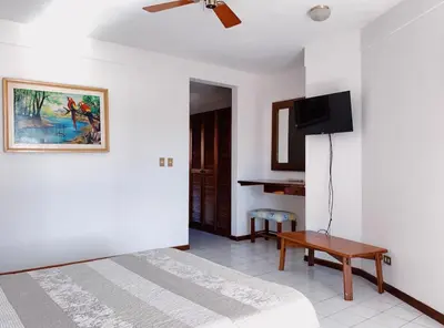 a bedroom with a bed and a flat screen tv at Flamingo Marina Hotel in Playa Flamingo