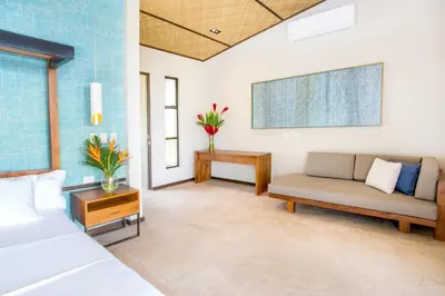 a living room with a couch and a table at Hotel Three Sixty - Adults Only in Ojochal