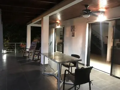 a table and chairs on the balcony of a house at Villas Lambeau 3 Ocean View - 2BR 3 BA in Uvita