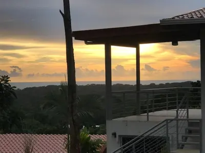 a view of the ocean from a house at sunset at Villas Lambeau 3 Ocean View - 2BR 3 BA in Uvita