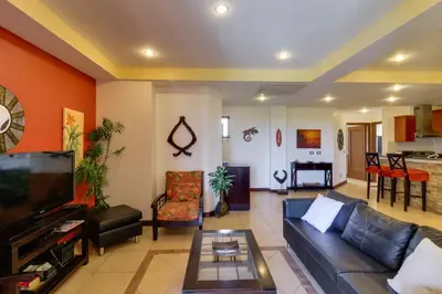 a living room with a couch and a table at Naxos 15 in Tamarindo
