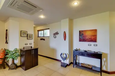 a living room with a fireplace and a tv at Naxos 15 in Tamarindo
