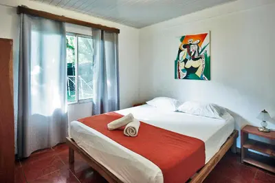 a bedroom with a bed and a window at Villa Picasso in Santa Teresa Beach