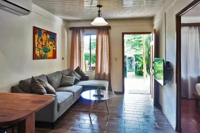 a living room with a couch and a table at Villa Picasso in Santa Teresa Beach