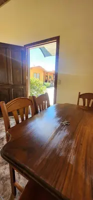a wooden table in a room with chairs around it at Cabina monteverde Soan de Montaña in Monteverde Costa Rica