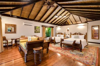 a living room with two beds and a couch at Hideaway Rio Celeste Hotel in Bijagua