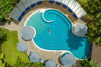 an overhead view of a swimming pool with umbrellas at Hideaway Rio Celeste Hotel in Bijagua