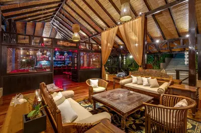 a living room with a couch and chairs and a table at Hideaway Rio Celeste Hotel in Bijagua