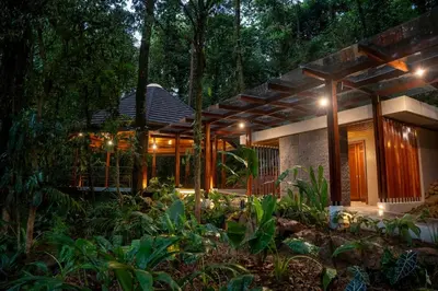 a house in the middle of a forest at night at Hideaway Rio Celeste Hotel in Bijagua