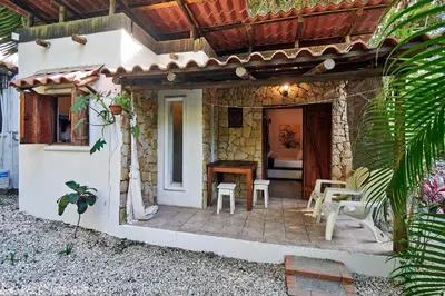 a house with a patio with a table and chairs at Casas Mal Pais in Mal País