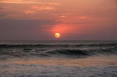 a sunset over the ocean with the sun in the horizon at Casas Mal Pais in Mal País