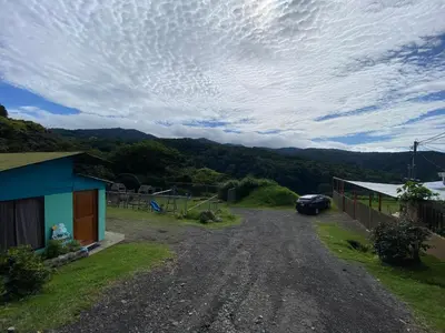 a dirt road with a car parked next to a house at Lidia's Mountain View Vacation Homes in Monteverde Costa Rica
