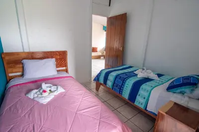 a bedroom with two beds with towels on them at Lidia's Mountain View Vacation Homes in Monteverde Costa Rica