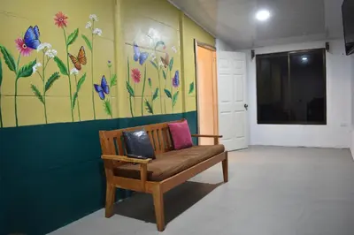 a chair in a room with a painting on the wall at Lidia's Mountain View Vacation Homes in Monteverde Costa Rica