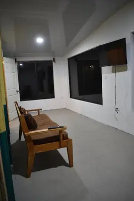 a room with a couch and two large windows at Lidia's Mountain View Vacation Homes in Monteverde Costa Rica