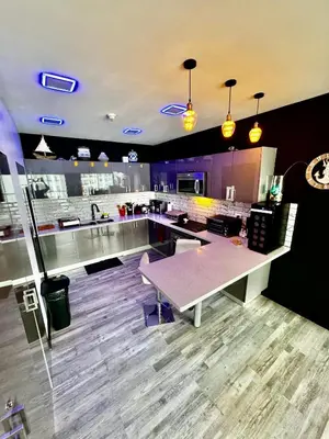 a large kitchen with a table in the middle at Luxury Condo at Jaco Bay, Costa Rica's best beach in Jacó