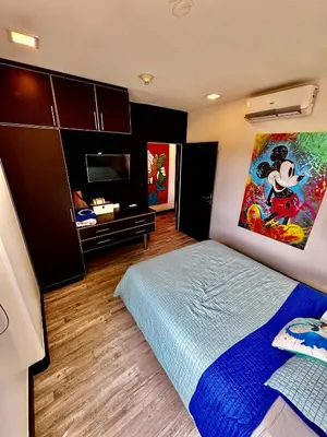 a bedroom with a bed and a flat screen tv at Luxury Condo at Jaco Bay, Costa Rica's best beach in Jacó