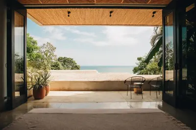a room with a view of the beach from a house at Mint Santa Teresa - Adults only in Santa Teresa Beach