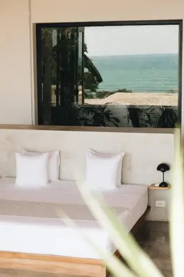 a bedroom with two beds and a large window at Mint Santa Teresa - Adults only in Santa Teresa Beach