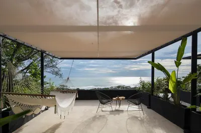 a house with a view of the ocean from the balcony at Mint Santa Teresa - Adults only in Santa Teresa Beach