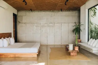 a bedroom with a bed and a couch and a table at Mint Santa Teresa - Adults only in Santa Teresa Beach