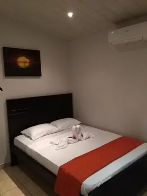 a bedroom with a bed with a stuffed animal on it at Arenal Thiago with Private Jacuzzi in Fortuna