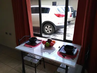 a table with a bowl of fruit on it next to a window at Arenal Thiago with Private Jacuzzi in Fortuna