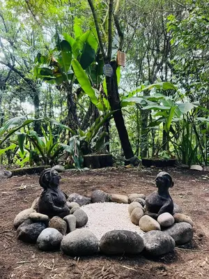 two statues of dogs sitting on a rock formation at Apartamento ArteSAna - Jardín de la Diosa in Monteverde Costa Rica