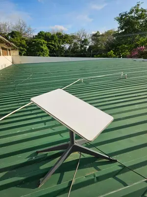 a white chair sitting on top of a tennis court at Trebolmar Apartments for remote work in Santa Teresa Beach