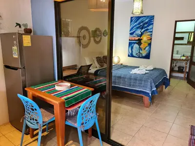 a room with a table and a bed and a mirror at Trebolmar Apartments for remote work in Santa Teresa Beach