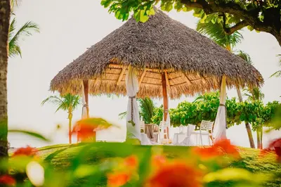 a large straw hut with chairs and tables at Fiesta Resort All Inclusive Central Pacific - Costa Rica in El Roble