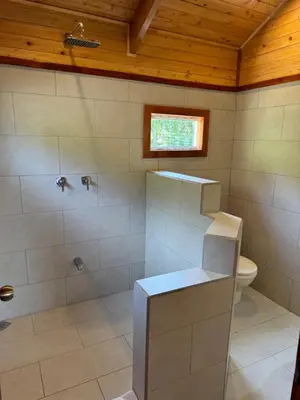a large bathroom with a shower and a toilet at Los Lagos Lodge in San Gerardo de Dota