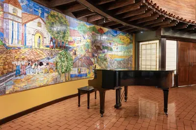 a grand piano in a room with a mural at Hilton Cariari DoubleTree San Jose - Costa Rica in San José