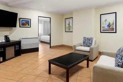 a living room with a couch and a tv at Hilton Cariari DoubleTree San Jose - Costa Rica in San José