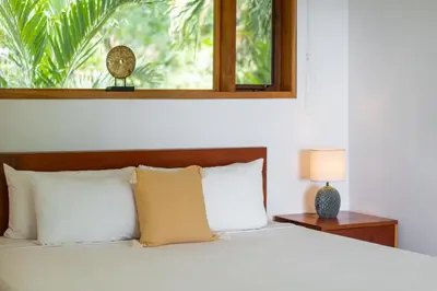 a bedroom with a bed with a window at Villa Makai Santa Teresa in Santa Teresa Beach