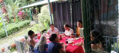 a group of people sitting at a table eating at Cabins yafeth osa drake bay in Drake