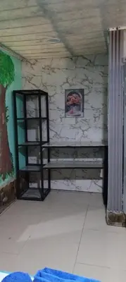 a room with a shelf in a stone wall at Cabins yafeth osa drake bay in Drake