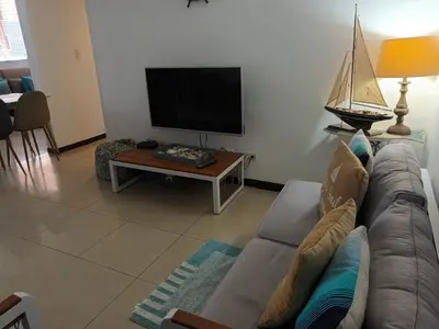 a living room with a couch and a tv at 2Bed 2Bath Jaco Costa Linda in Jacó